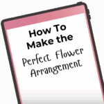 A tablet screen displaying the text "How To Make the Perfect Flower Arrangement" in bold and playful fonts against a gradient pink background.