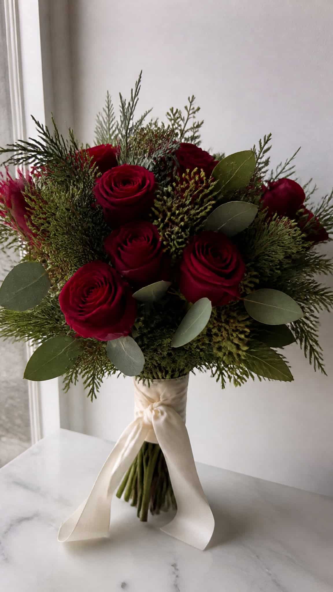 Classic Red Roses with Winter Greenery