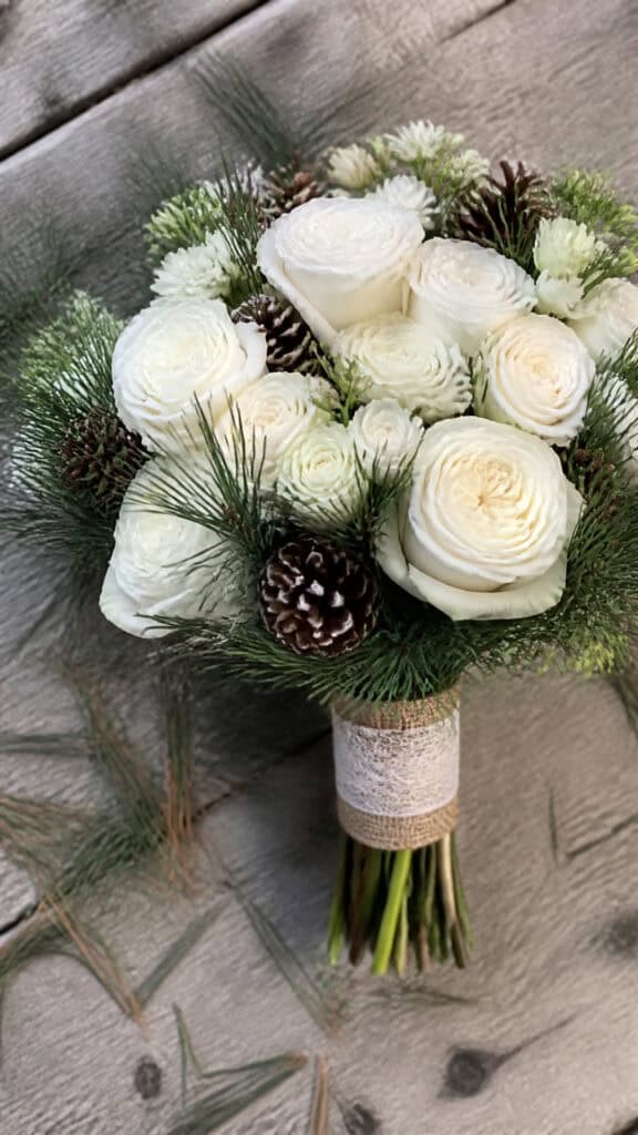 Snowy White Garden Roses with Pine and Pinecones